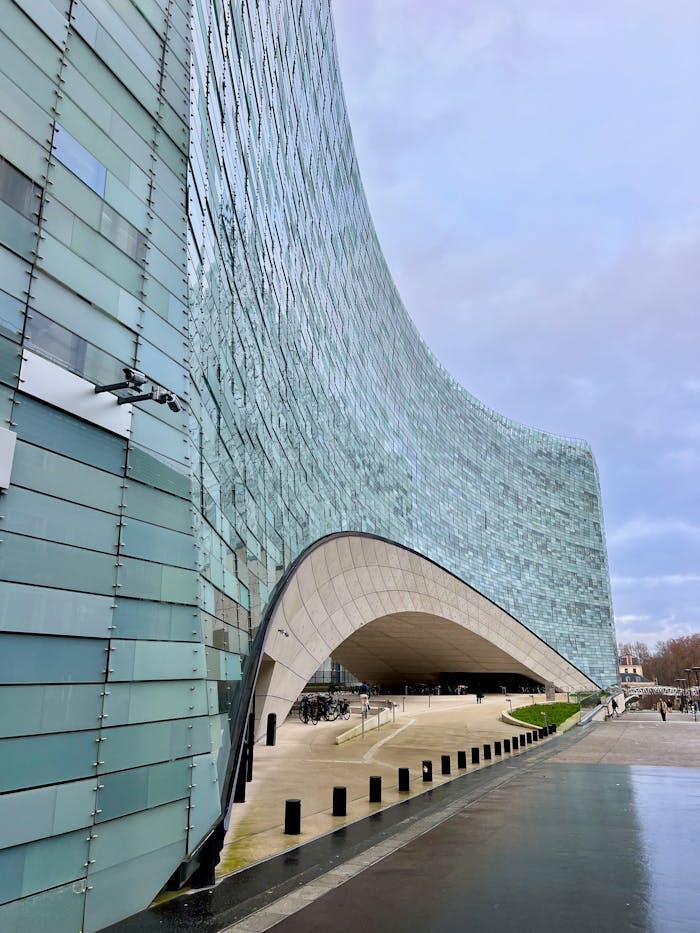 A striking modern architectural office building with a curved glass facade.
